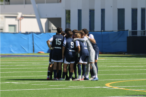 The Varsity Boys Soccer Team huddles on the pitch before the game begins. They beat Immaculata-La Salle High School during the fourth match of the season yesterday. They huddled before the match so that the leaders of the team motivated everyone to perform at their best. Their next game is against Westminster Christian on Nov. 28.